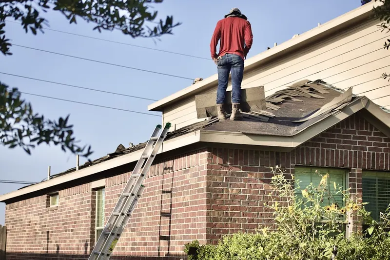 Professional roofer working on a residential roof in Ridgway